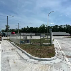 Galvanized chain link around a utility enclosure at a new commercial lot